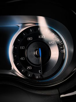 A detailed close-up of a car speedometer, highlighting speed and control.