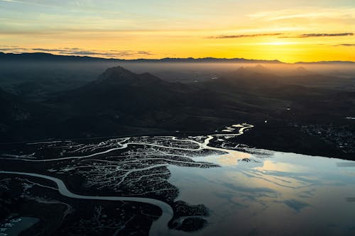 Free A sunset over a river and mountains Stock Photo