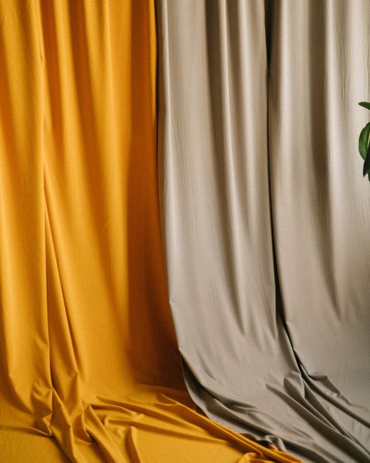 Stylish yellow and gray draped curtains for modern interior decor. Perfect for creating a sophisticated atmosphere.