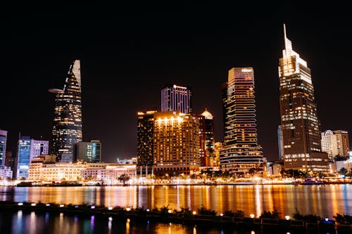 A city skyline lit up at night with water