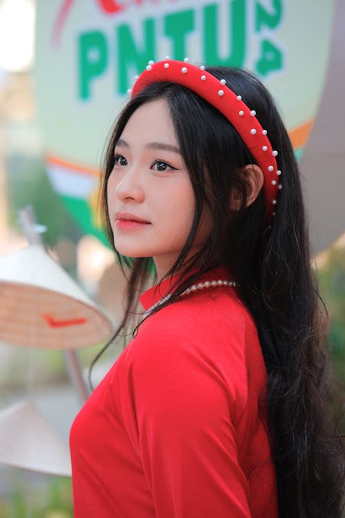 A young woman in red is posing for a photo