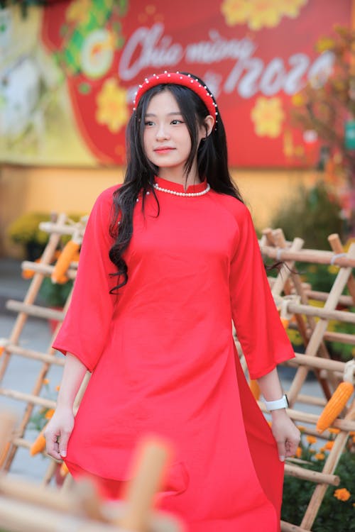 A young asian woman in a red dress