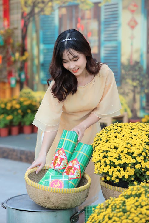 Young Woman with Rolls of Paper in a Wicker Basket 