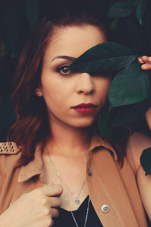 Free Woman Covering Eye With Leaf Stock Photo