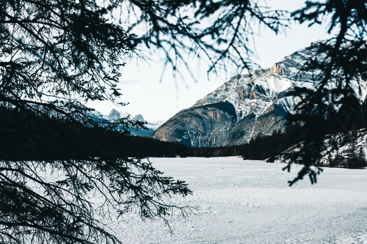 A breathtaking view of snowy mountains and a frozen lake in Banff National Park.