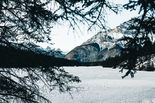 Free A breathtaking view of snowy mountains and a frozen lake in Banff National Park. Stock Photo