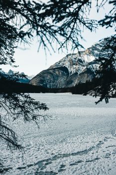 Scenic view of snowy mountains and frozen lake in Banff National Park, Alberta.