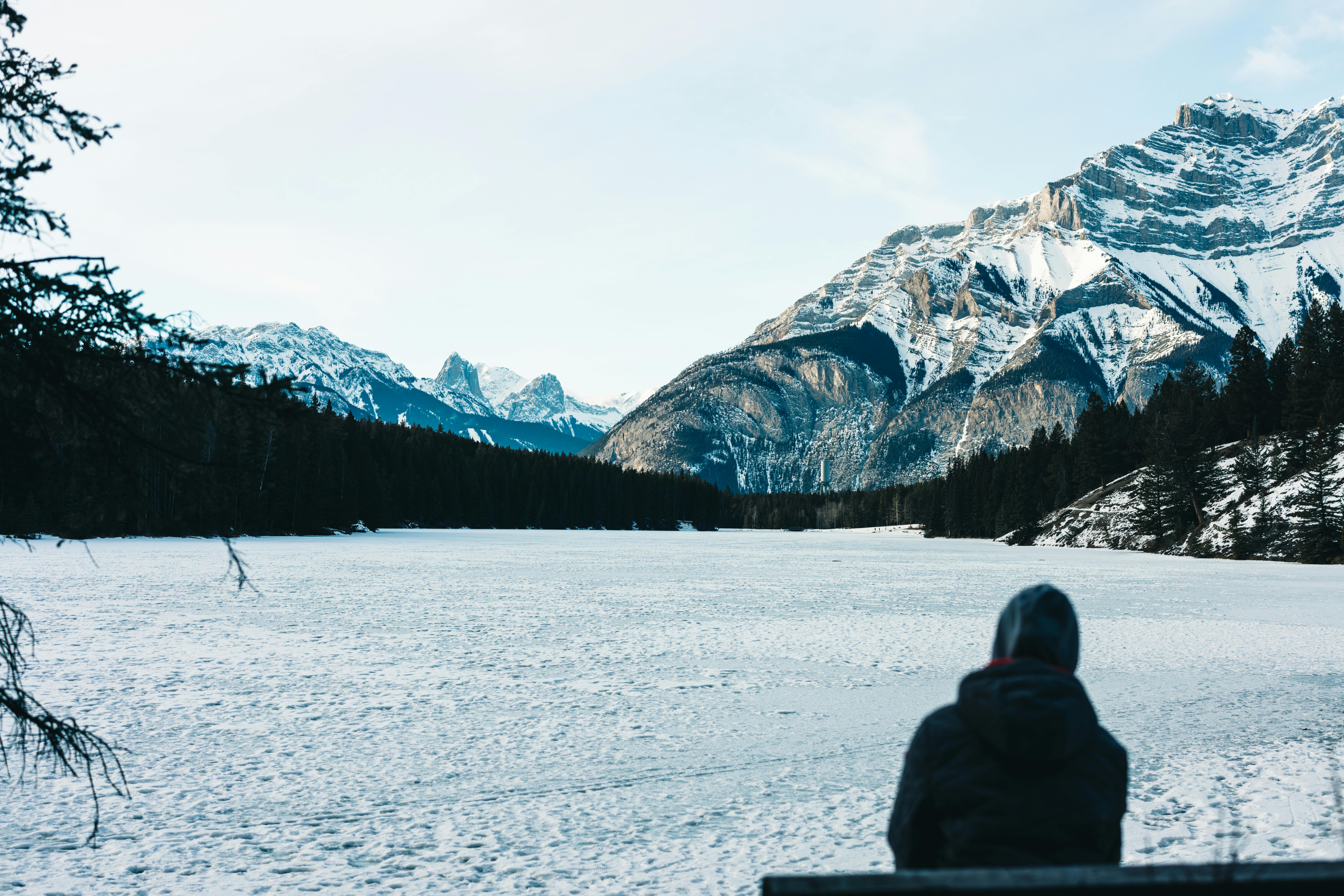 A person enjoying the serene winter landscape of mountainous Banff National Park, Canada.