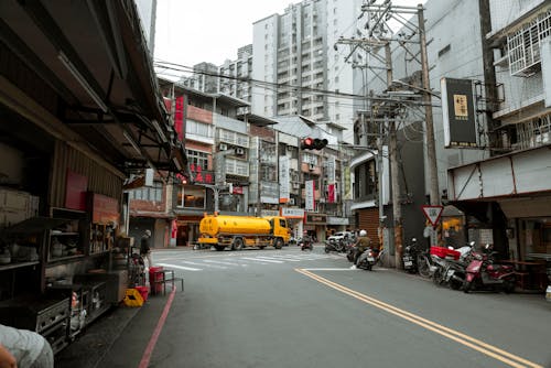 Truck and Motor Scooters in City