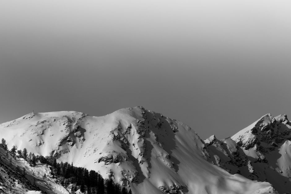 Majestic snow-capped mountain peaks under a clear winter sky.