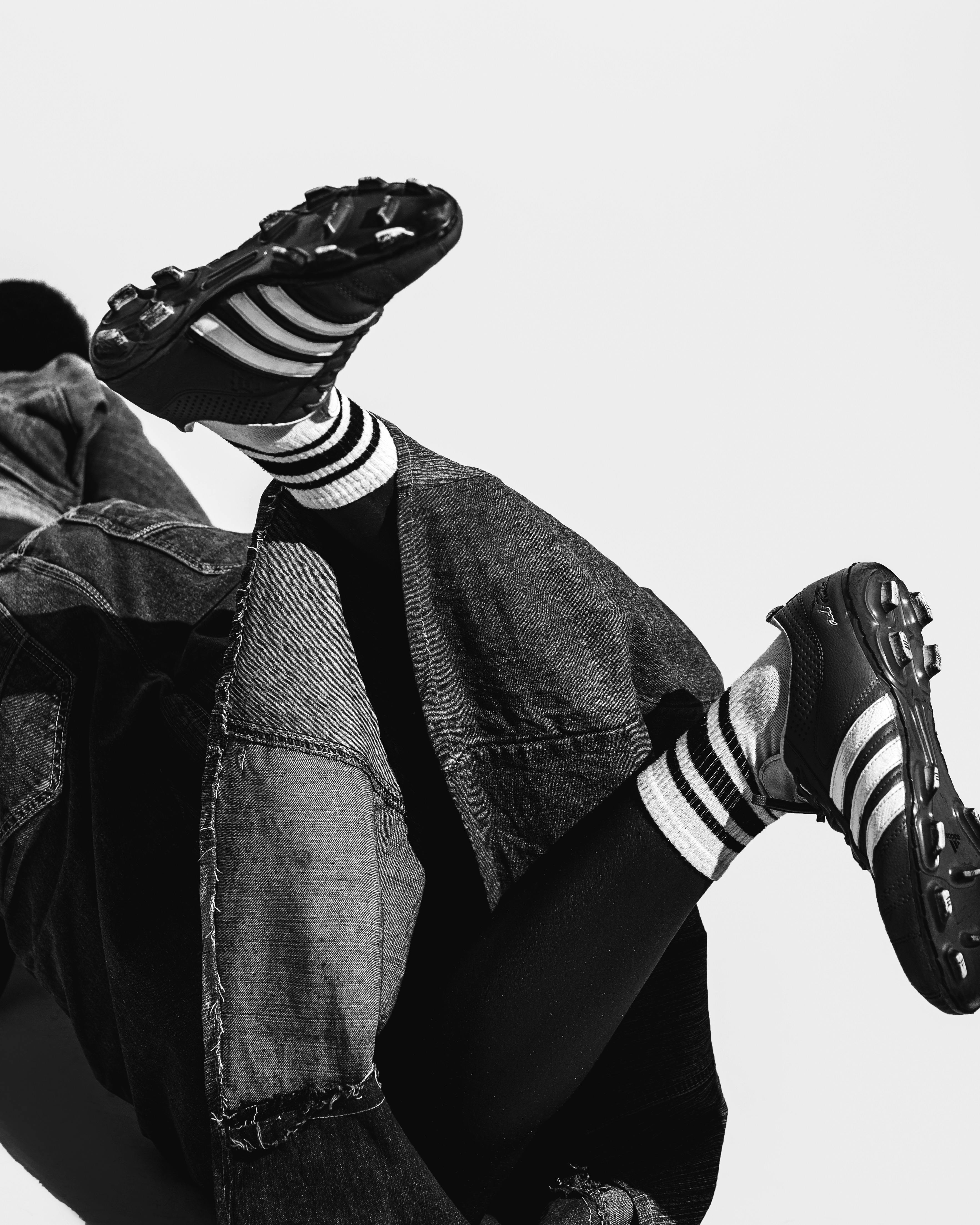 Black and white fashion portrait featuring denim and sportswear elements.