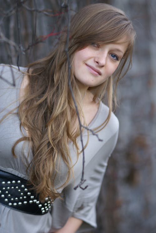 A young woman with long hair posing for a picture