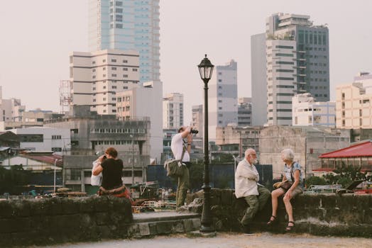 Photographers capture a vibrant cityscape in Manila with modern architecture and social interactions.