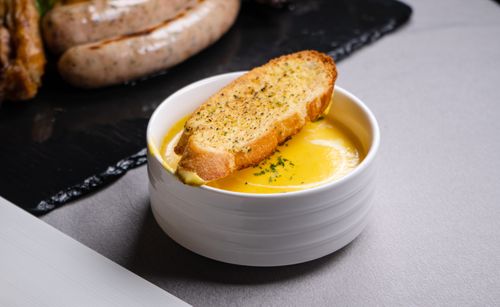 Free Delicious garlic bread served with a creamy cheese dip, perfect for a savory appetizer. Stock Photo