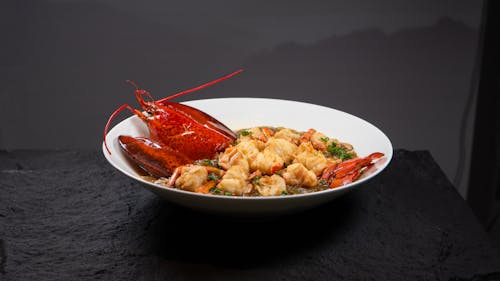 A bowl of lobster and rice on a table