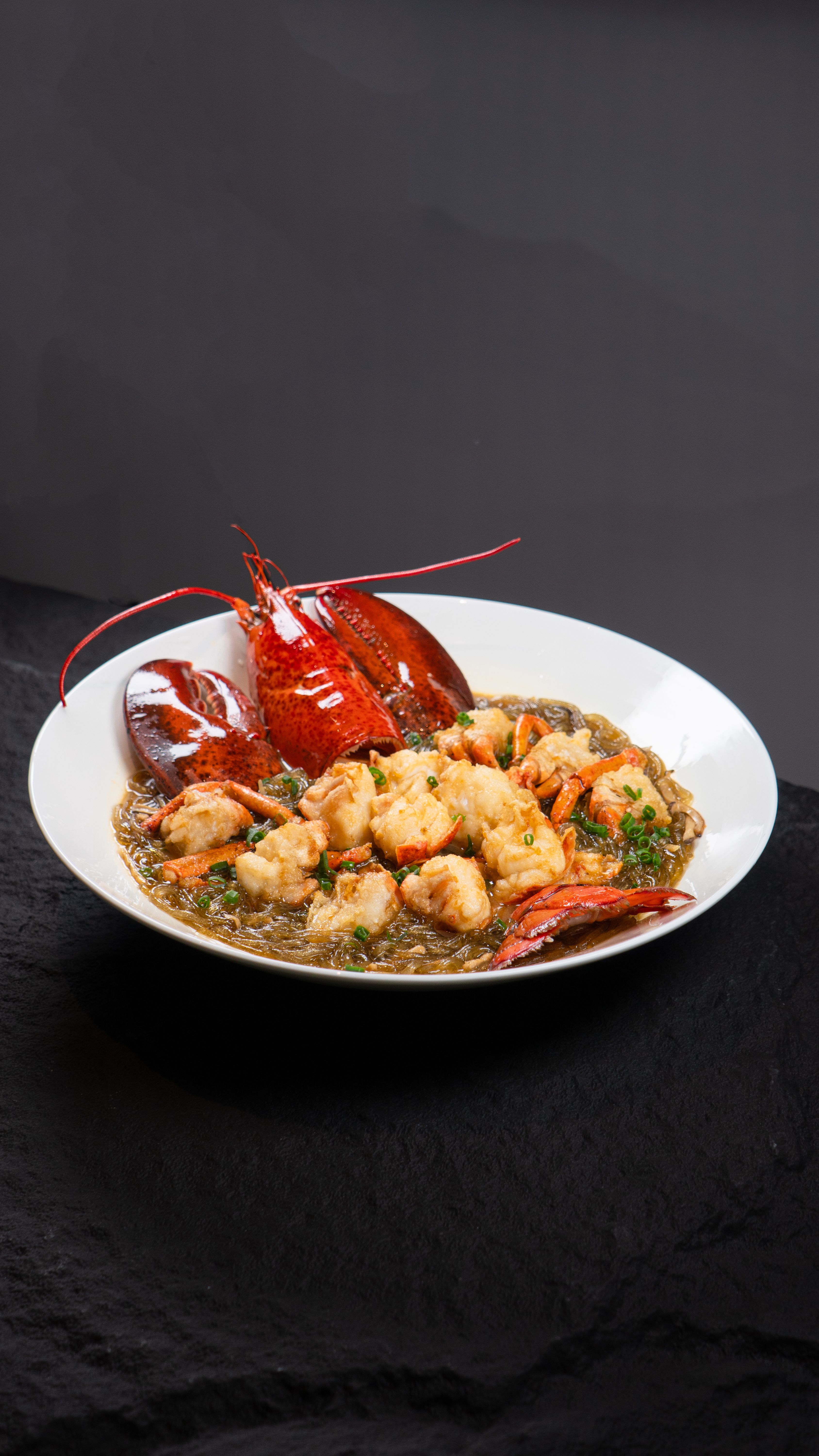 Delicious cooked lobster on a plate, perfect for gourmet food photography.