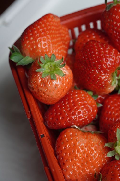 Free Bright red strawberries in a basket, showcasing their freshness and vibrant color. Stock Photo