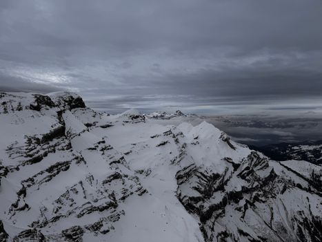 A snowy mountain landscape view from Saanen, Switzerland, showcasing the rugged beauty of the Alps.