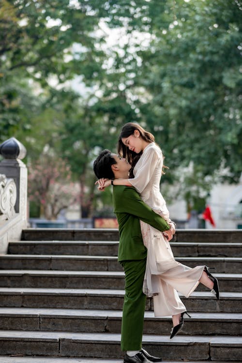 Couple in Traditional Clothing Hugging and Kissing