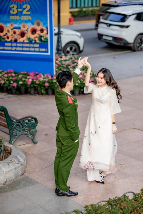 Smiling Couple in Traditional Clothing Holding Hands