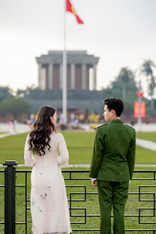 Back View of Couple in Traditional Clothing at Park