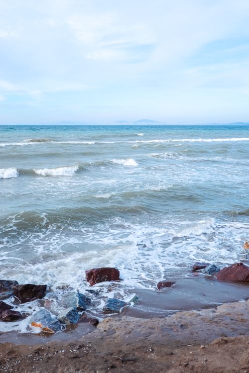 Free Idyllic beach scene with waves and rocks at Yalova, Türkiye, perfect summer day. Stock Photo