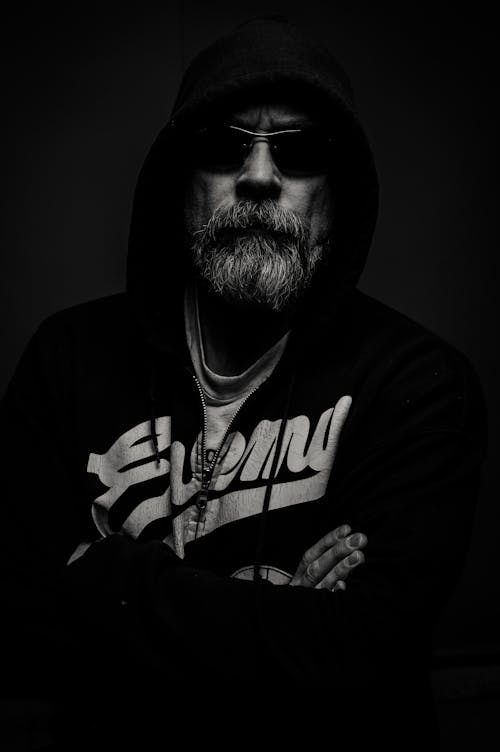 Grayscale Photography of Man Wearing Hooded Jacket