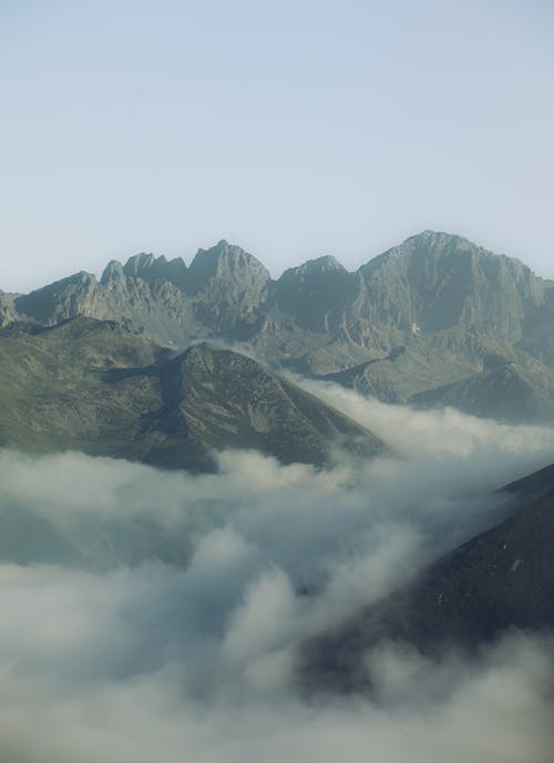 A view of mountains covered in clouds and fog