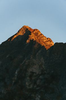 Majestic mountain peak bathed in sunlight in Valle d'Aosta, Italy.