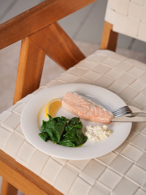 A Healthy Meal with Fish and Spinach on a White Plate 