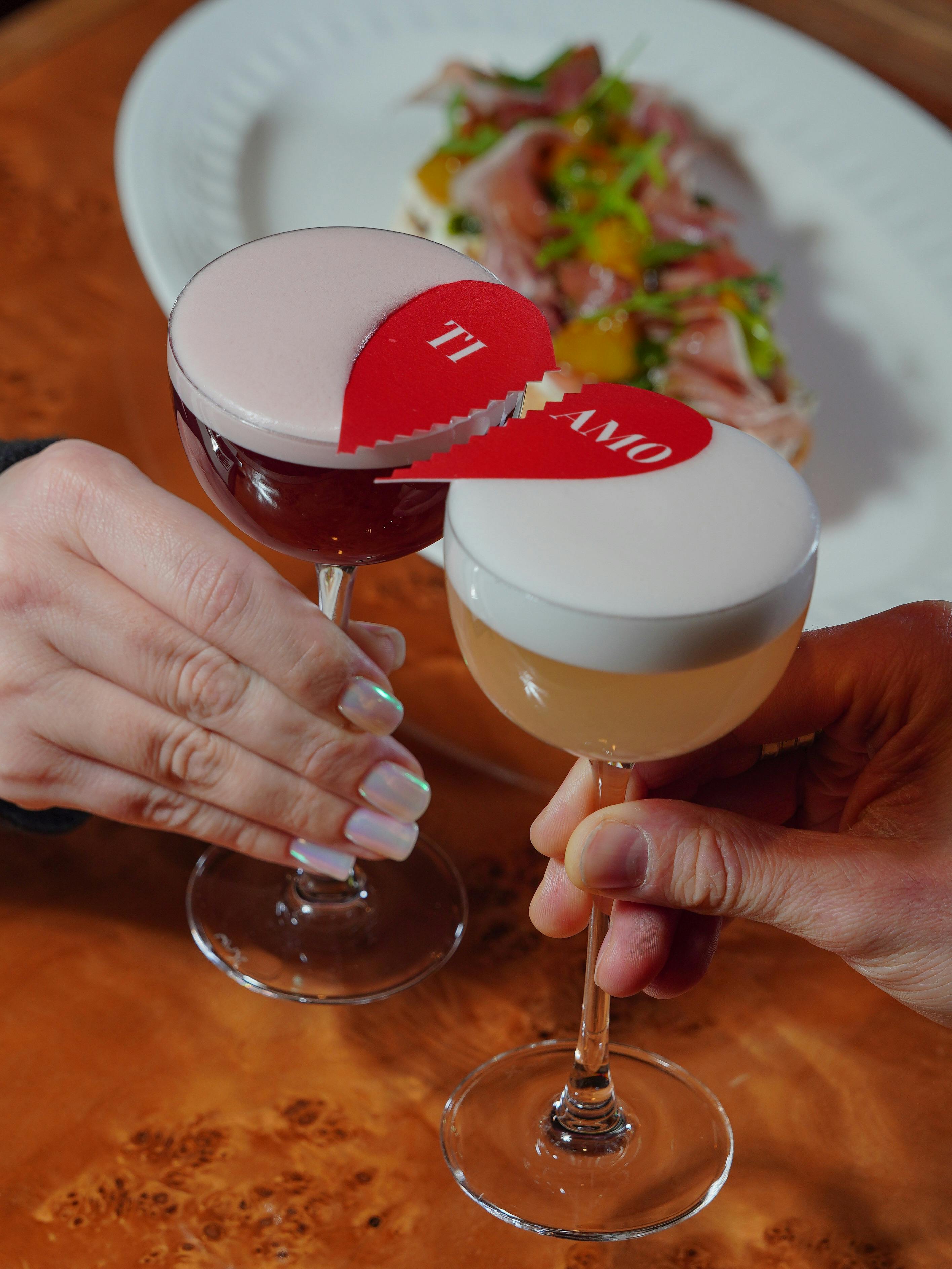 Close-up of two cocktails with 'Ti Amo' decoration, perfect for a romantic setting.