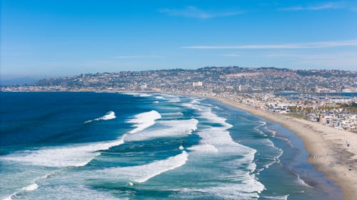 Waves in Bay with City on Sea Coast