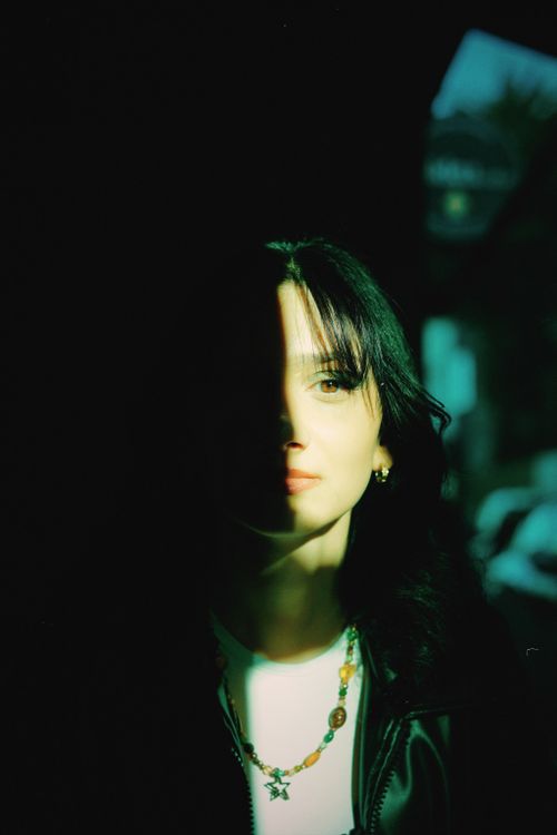 Free A captivating portrait of a woman with half-face shadows, shot in Samsun, Türkiye. Stock Photo