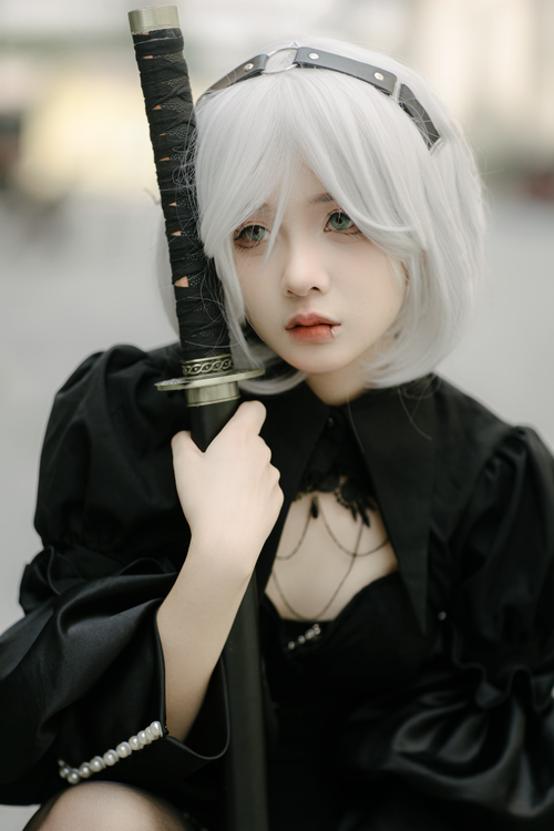 Free Cosplayer in black outfit holding a sword. Action anime theme, shot in Hà Nội, Vietnam. Stock Photo