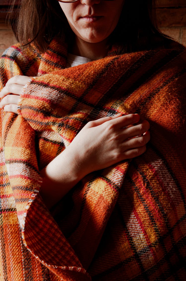 Close-up Of Woman Wrapped In A Checkered Blanket 