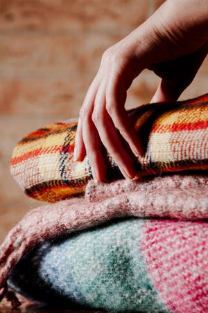 Folded woven wool blankets — photo by Boryslav Shoot on Pexels