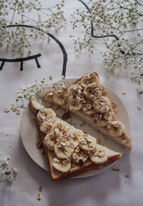 A slice of toast with bananas and flowers on it