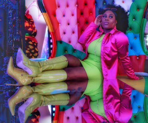A woman in a colorful outfit sitting on a chair