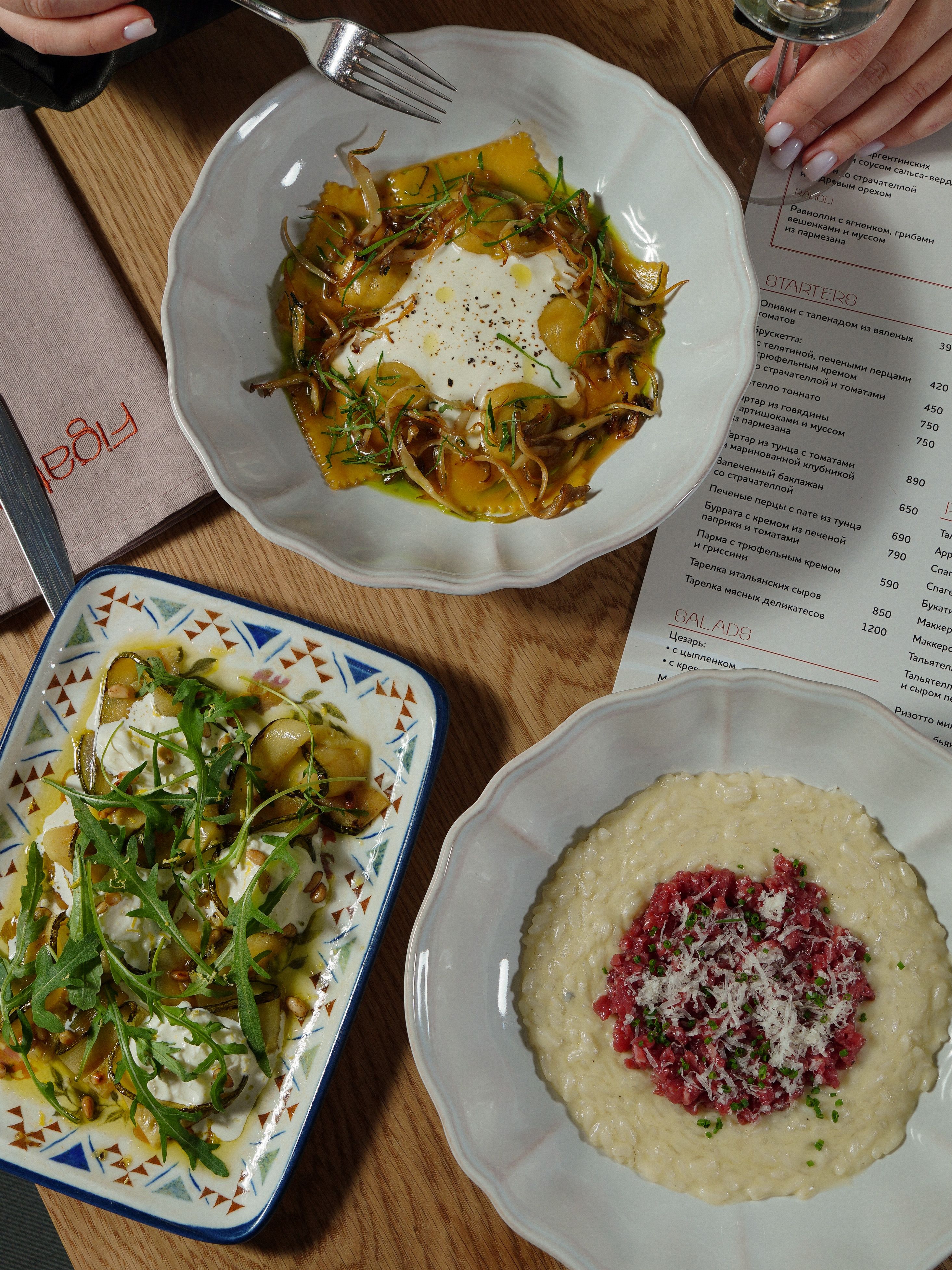An overhead view of Italian pasta dishes on a restaurant table, perfect for dining inspiration.