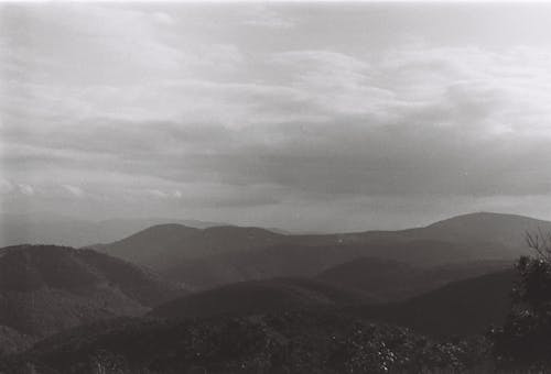 Black and white photo of mountains and clouds