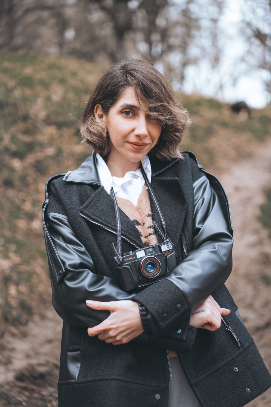 The photographer outdoors with a film camera