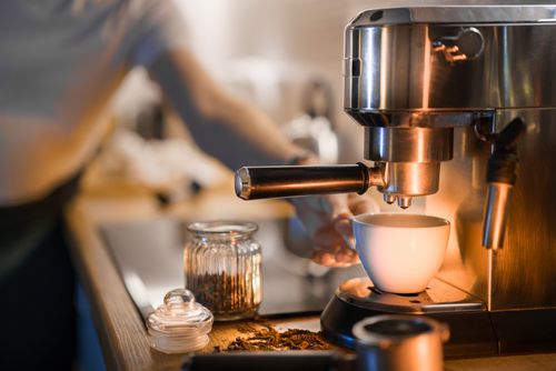 Free A barista prepares fresh espresso in a cozy café setting, perfect morning coffee vibe. Stock Photo