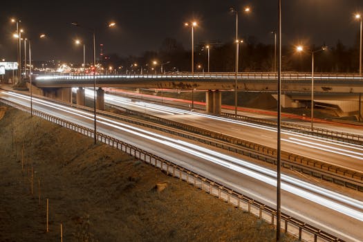 Captivating light trails of night traffic on a highway in Warsaw, capturing the urban essence and movement.