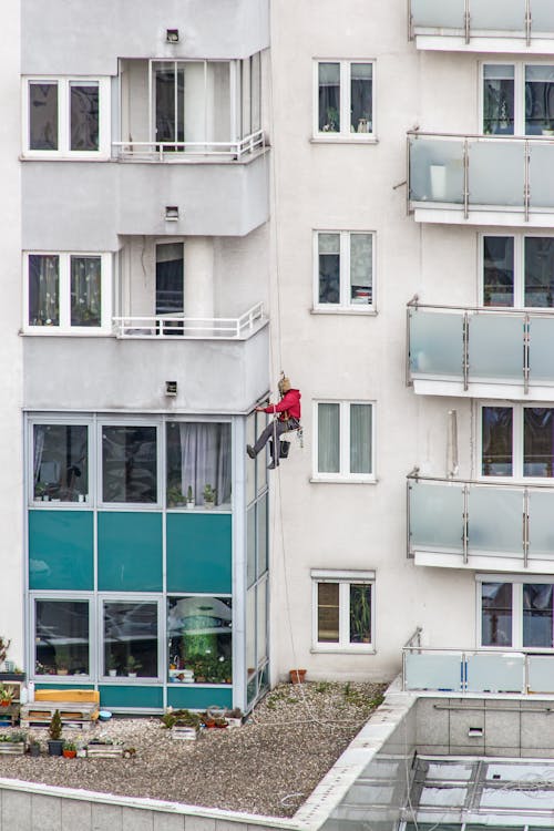 Man Working on Wall of Residential Building