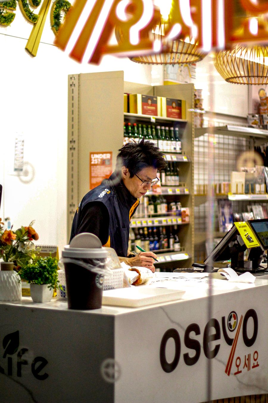 Supermarket staff at a checkout counter