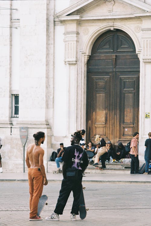 Group of Skateboarders in Front of Historic Building