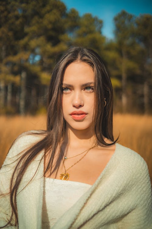 A beautiful young woman in a white sweater and necklace
