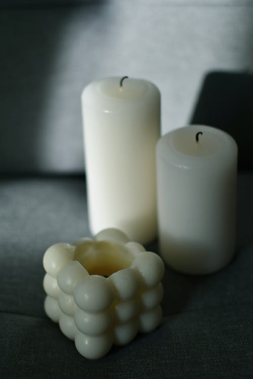 Close-up of White Candles in Different Shapes 