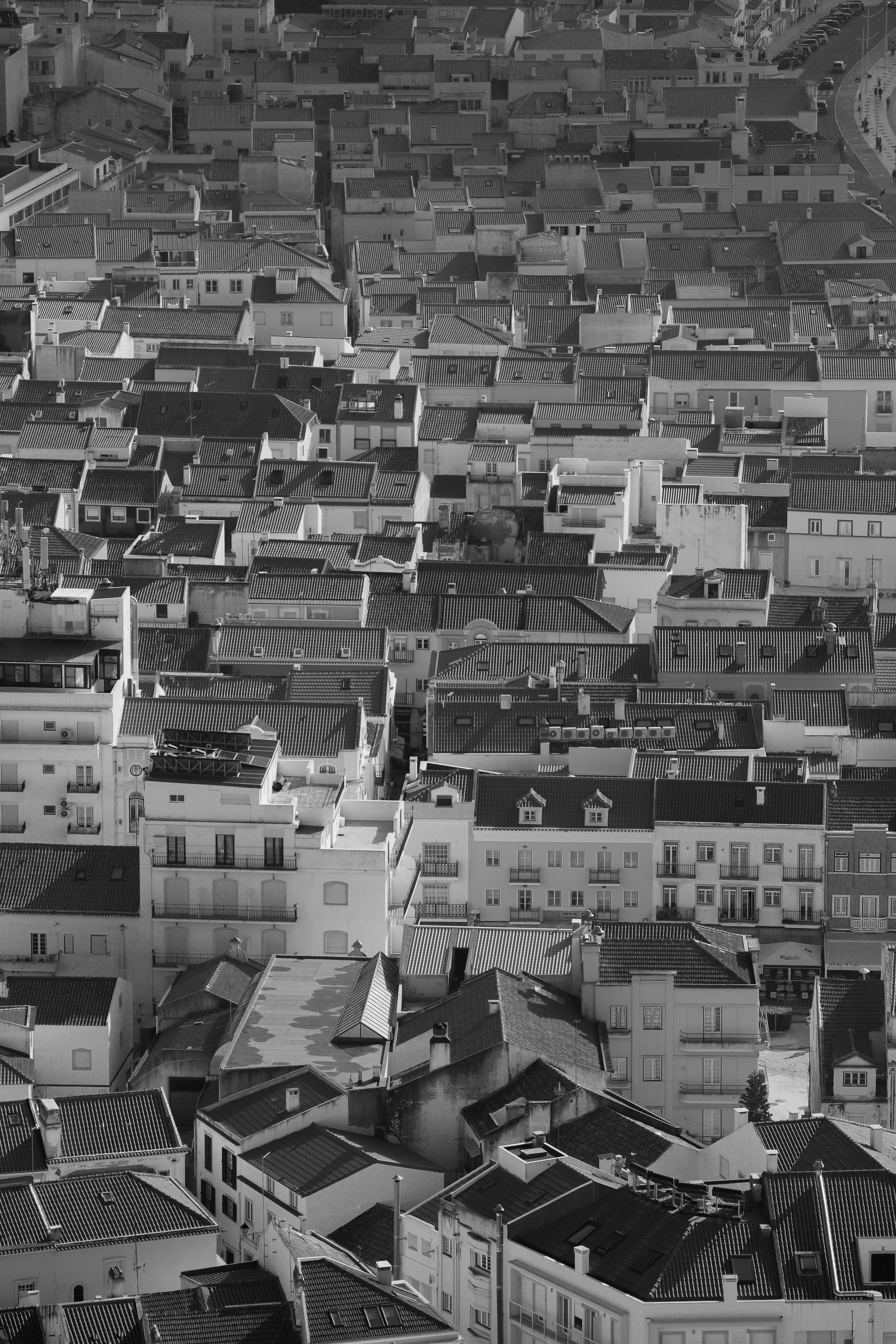 Black and white aerial view of Nazaré, Portugal showcasing intricate rooftops and urban architecture.