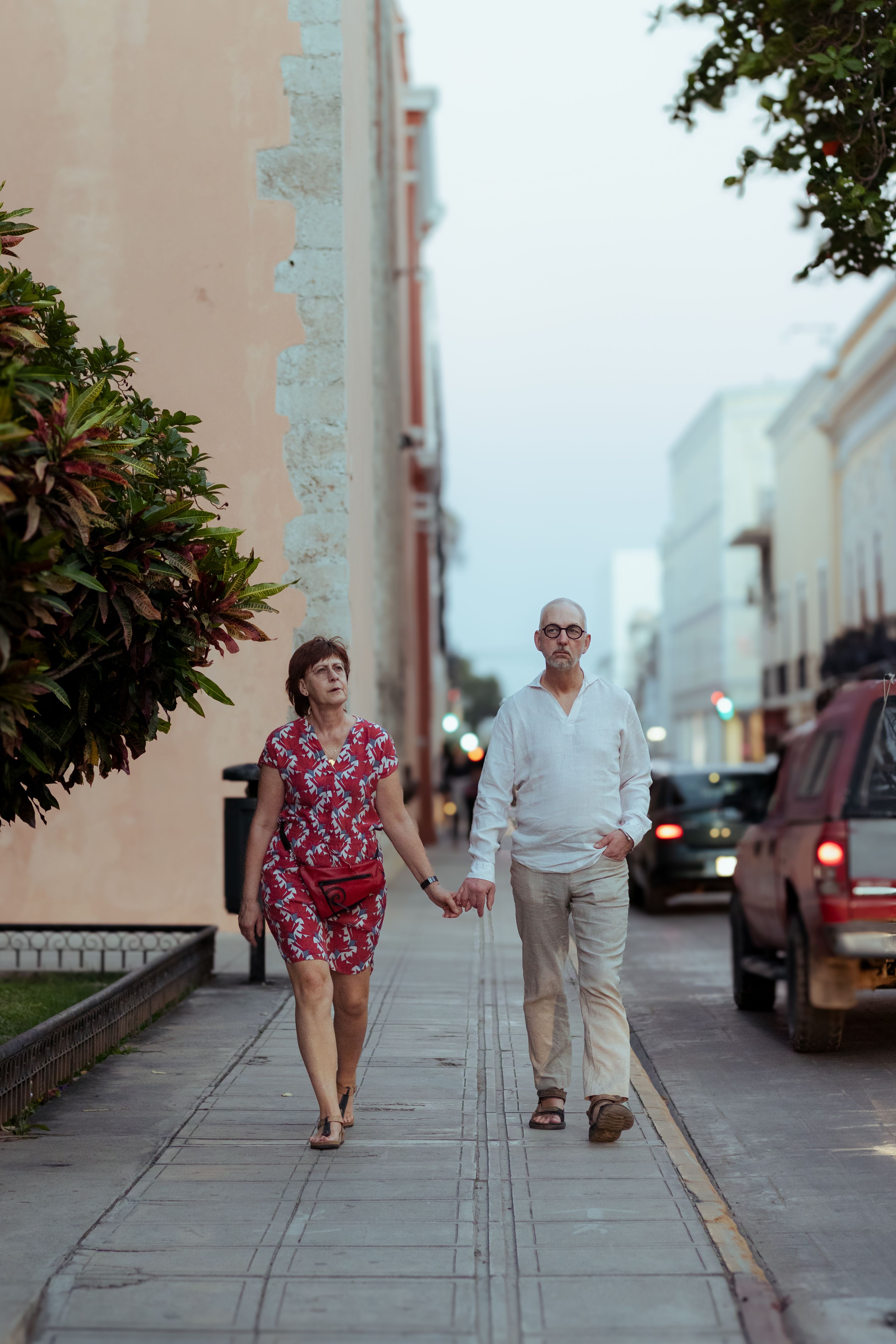 Couple Holding Hands and Walking on Sidewalk · Free Stock Photo